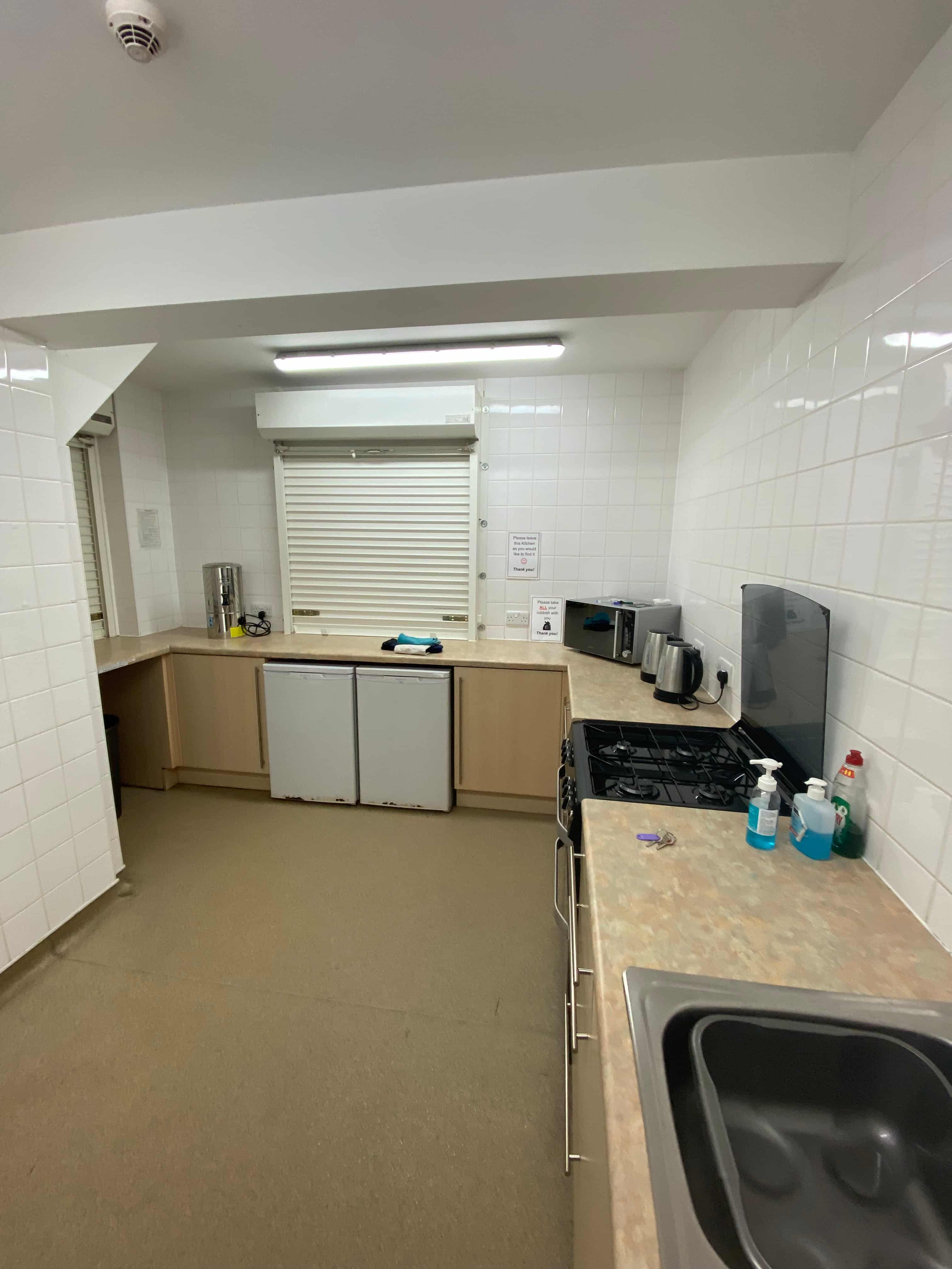 Kitchen area with worktops and serving access for the hall.