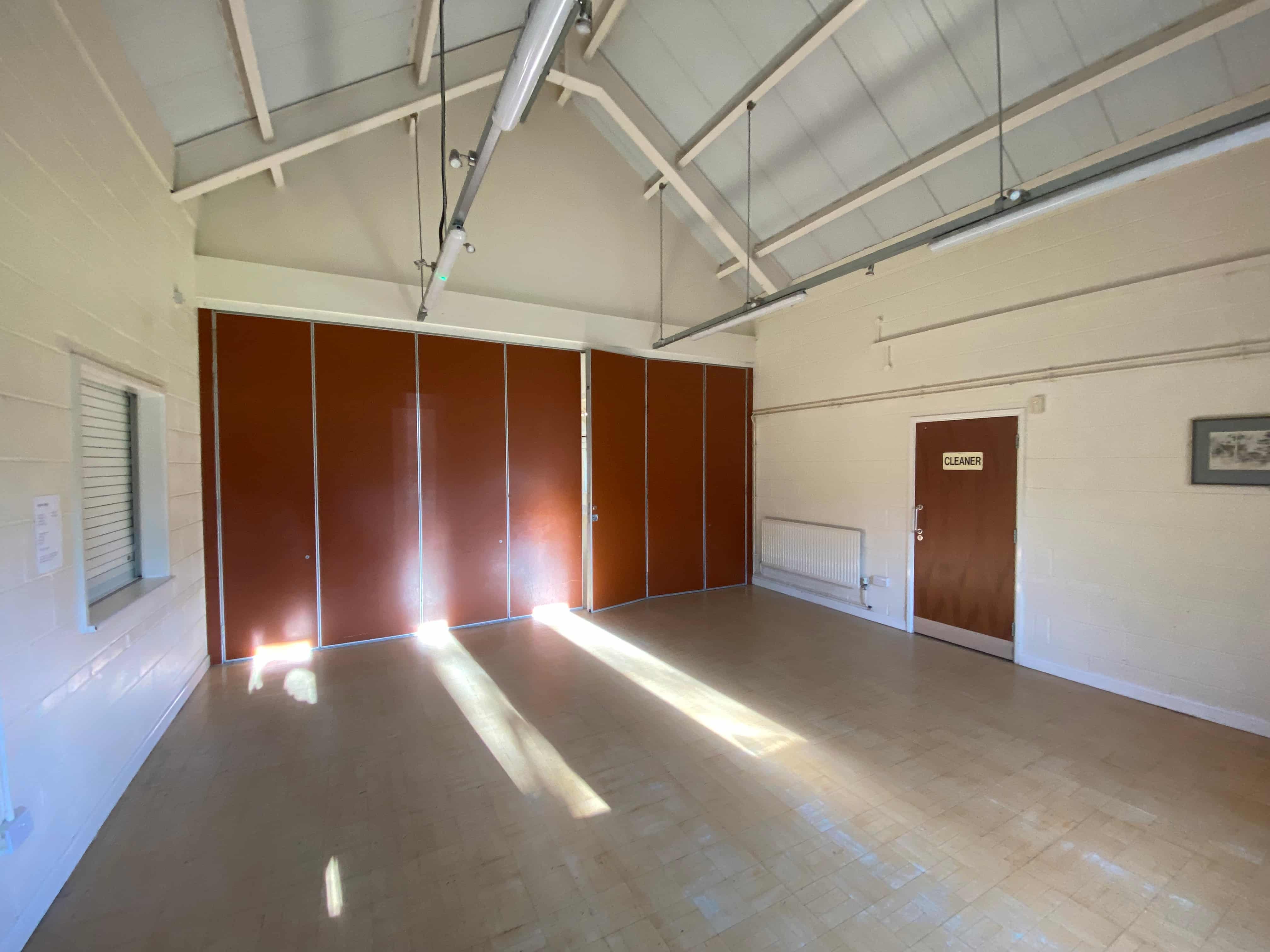 Main hall with a partition creating a smaller activity area.